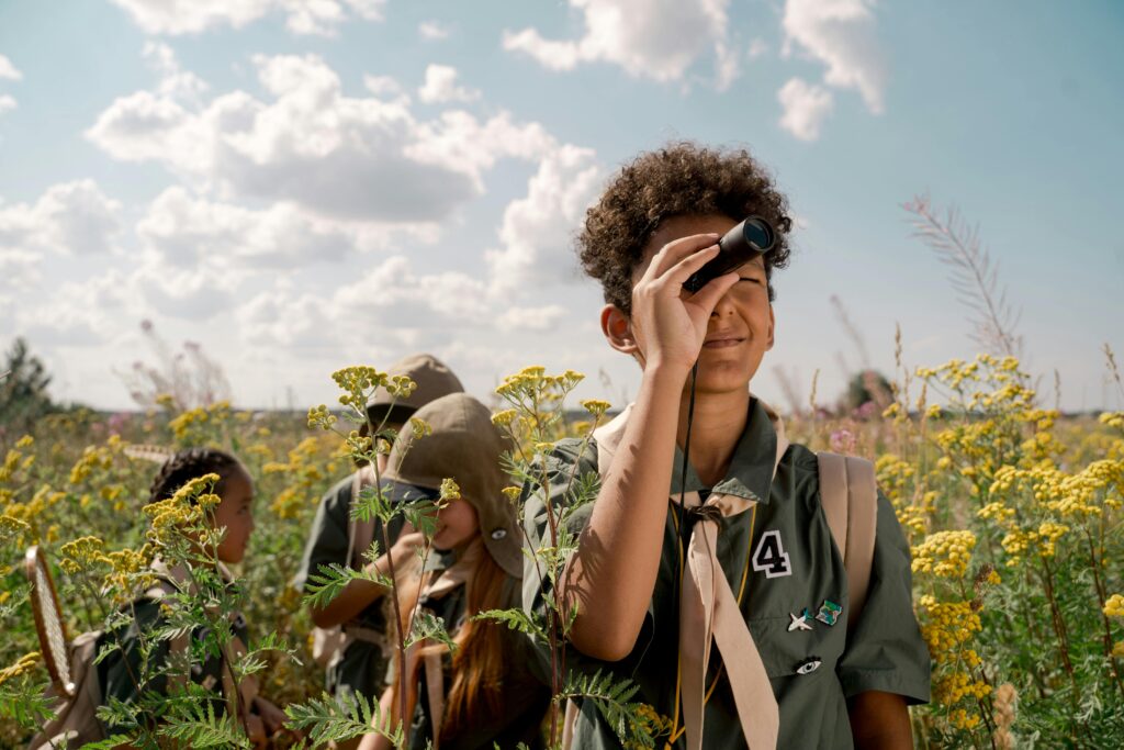 pexels photo 9290020 9290020 Group of young scouts observing nature with spotting scope in a summer field.
